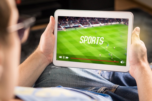 man watching sports on tablet