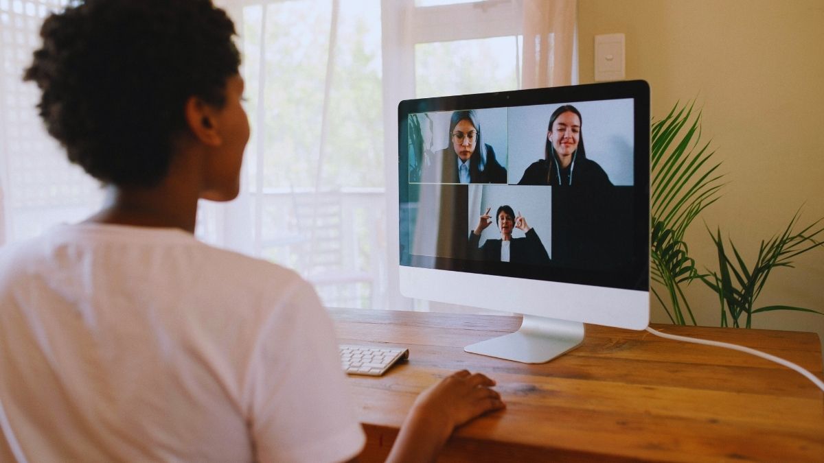 Guy in a video call with colleagues.